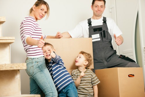 Movers carrying furniture in a stairwell
